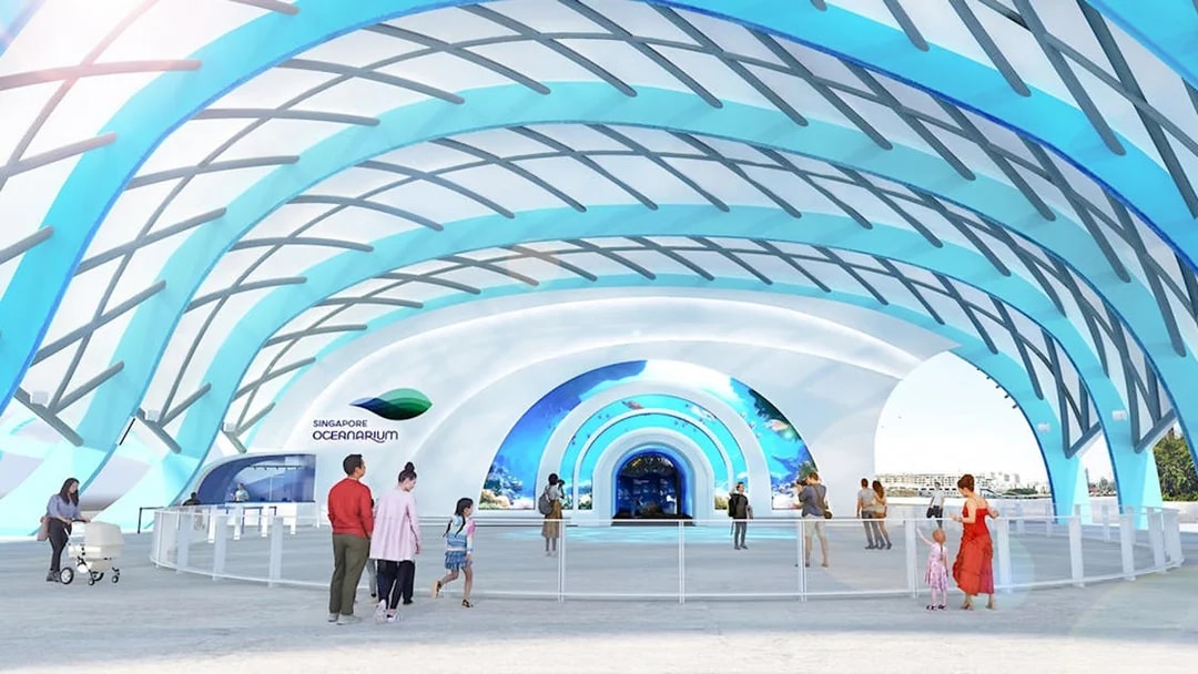 Visitors entering the Singapore Oceanarium under a modern, blue-arched structure.