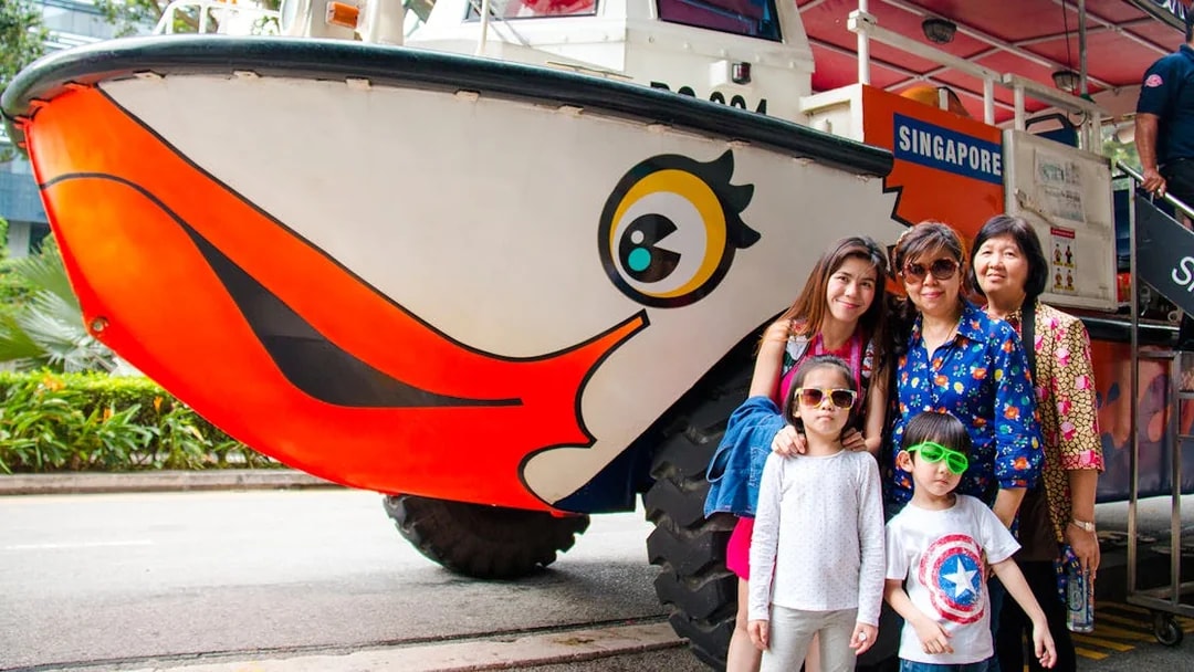 DUCKtours Singapore vehicle with a family posing in front.