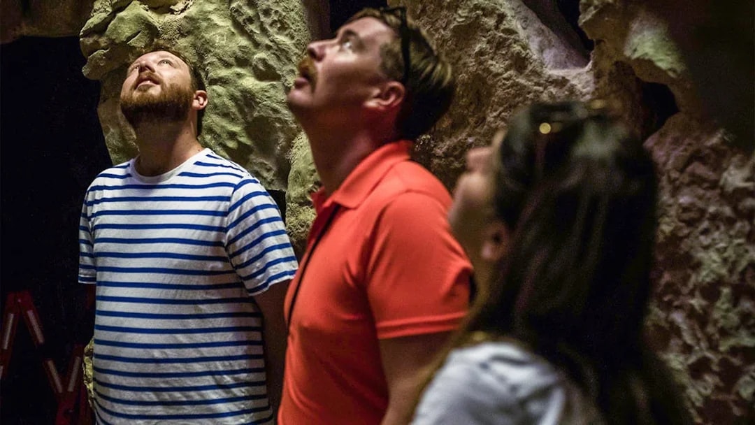Visitors exploring cave formations on Sintra Jeep Safari Tour.