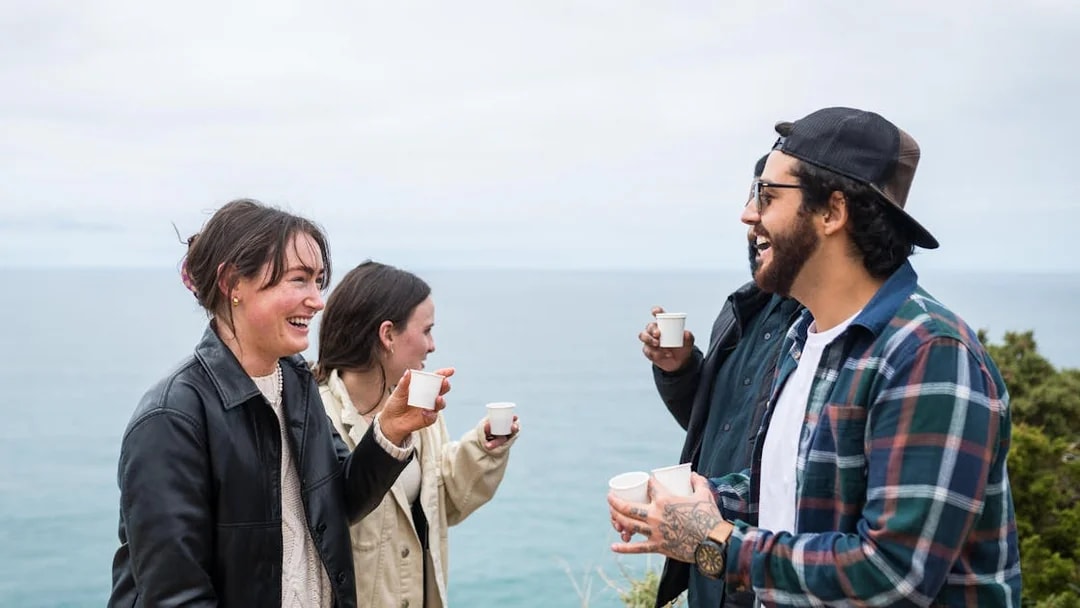 Group enjoying drinks on a Sintra Jeep Safari with ocean view.