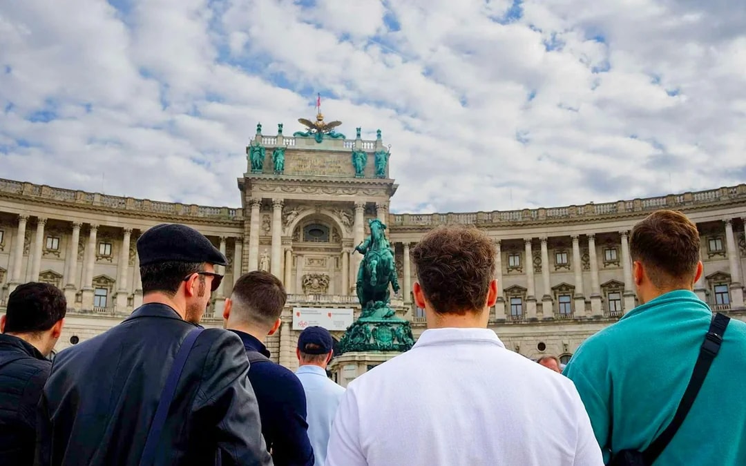 Tourists at Hofburg Palace in Vienna during a guided walking tour.