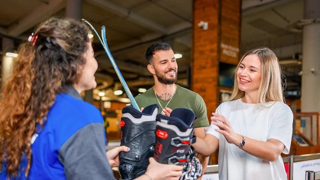 Couple receiving ski equipment at Ski Dubai.