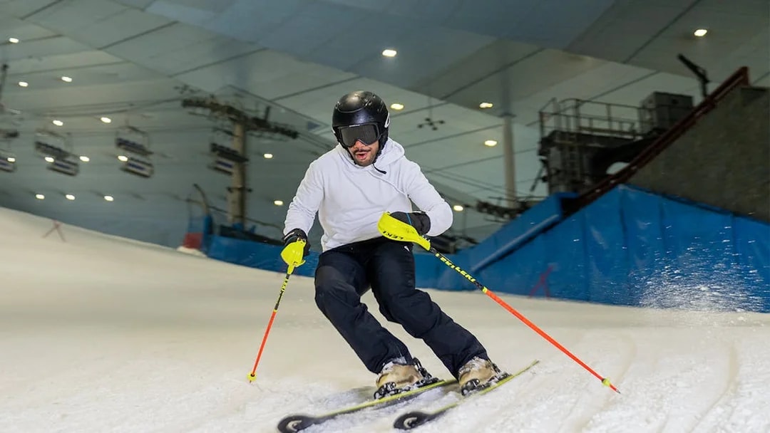 Skier navigating indoor slope at Ski Dubai during full day session.