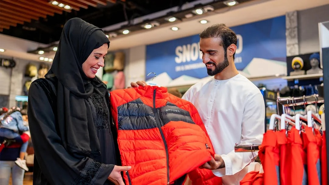 People selecting ski jackets at Ski Dubai Snow Park.