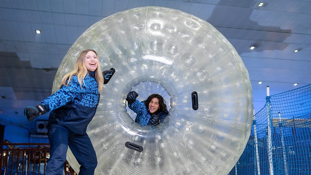Guests enjoying zorbing at Ski Dubai indoor snow park.