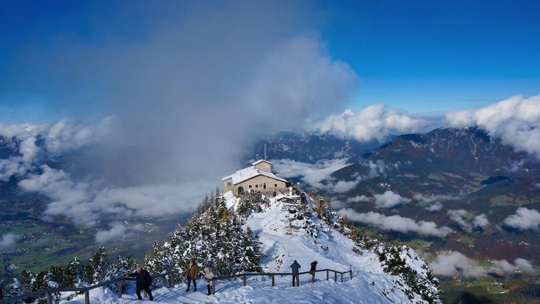 Eagle’s Nest in snow-covered mountains with visitors, view from Salzburg tour.