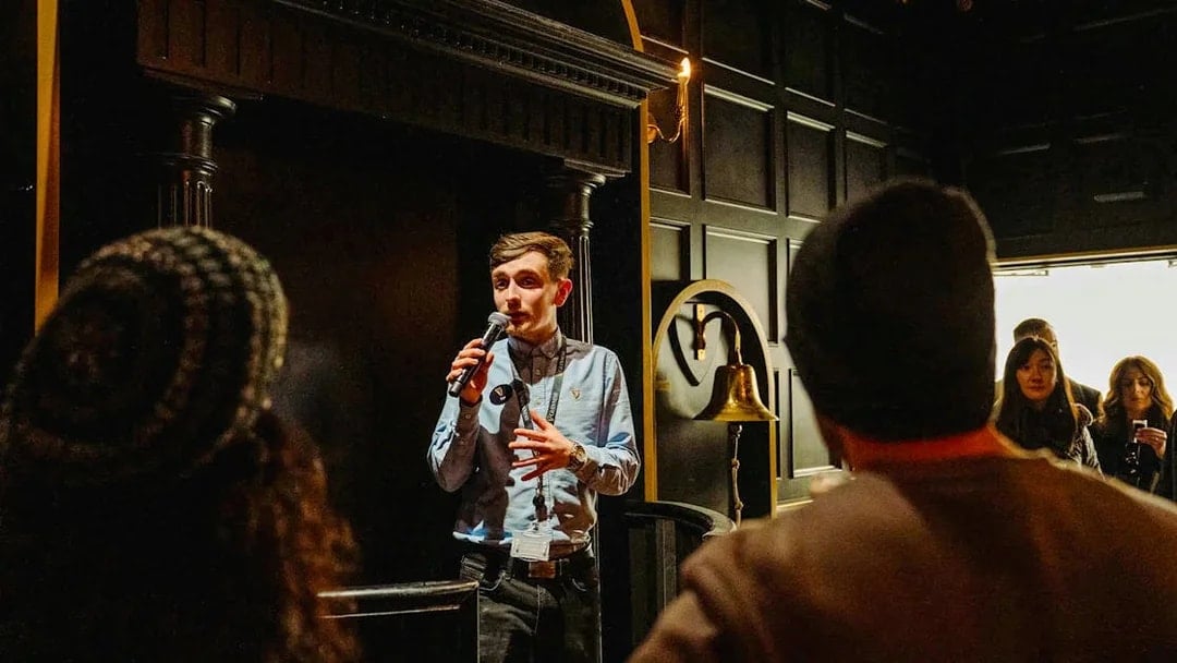 Tour guide speaking to visitors at Jameson Distillery, Dublin.