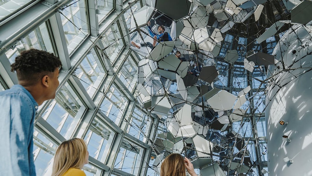 Visitors observing the geometric ceiling at Torre Glories Lookout.