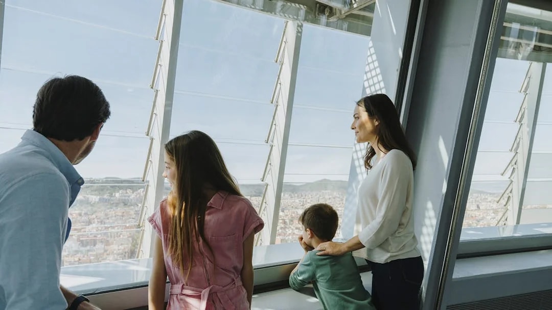 Family enjoying city view from Torre Glories Lookout in Barcelona.