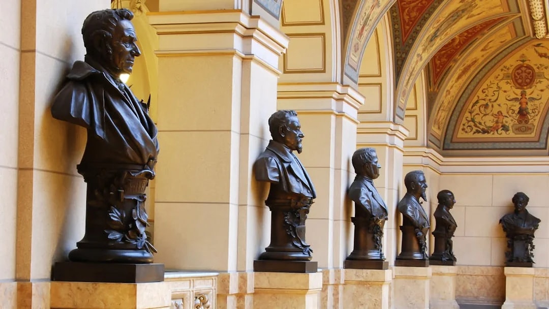 Busts lining the ornate hallway of the National Prague Museum interior.