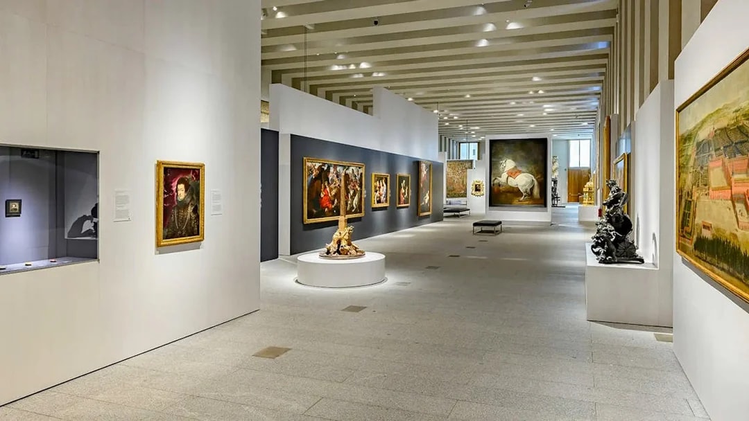 Royal Collections Gallery interior with paintings and sculptures, Madrid.