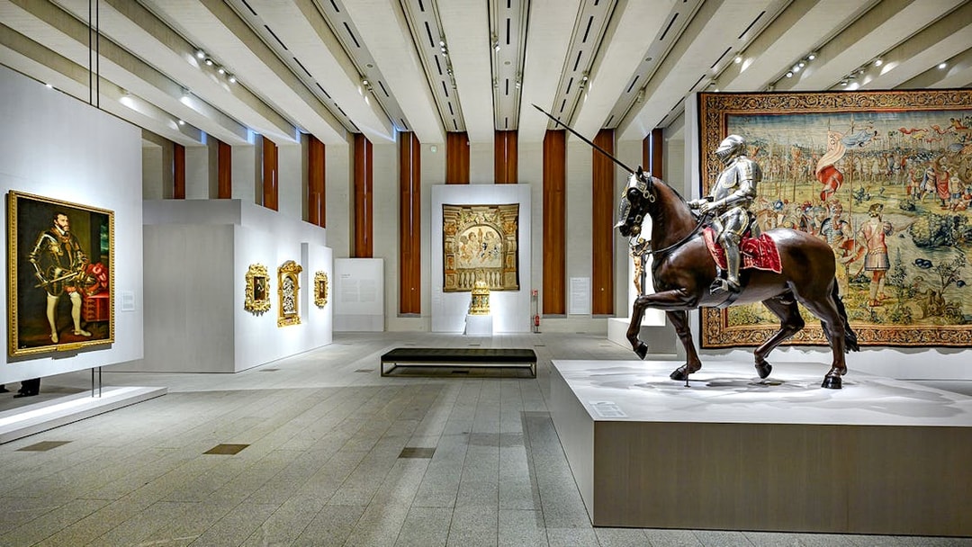Royal Collections Gallery interior with knight statue on horseback and historical paintings.