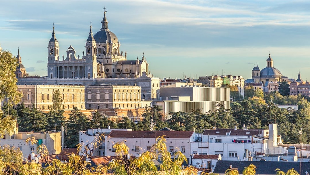 Royal Palace of Madrid and Almudena Cathedral viewed from a distance.