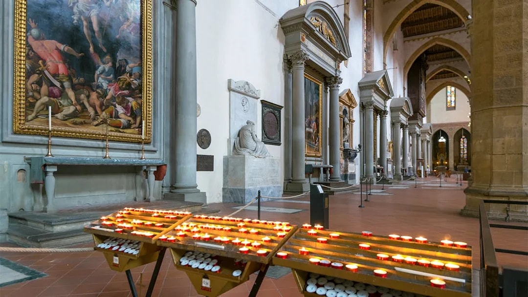 Candles and artwork inside Santa Croce Basilica, Florence.