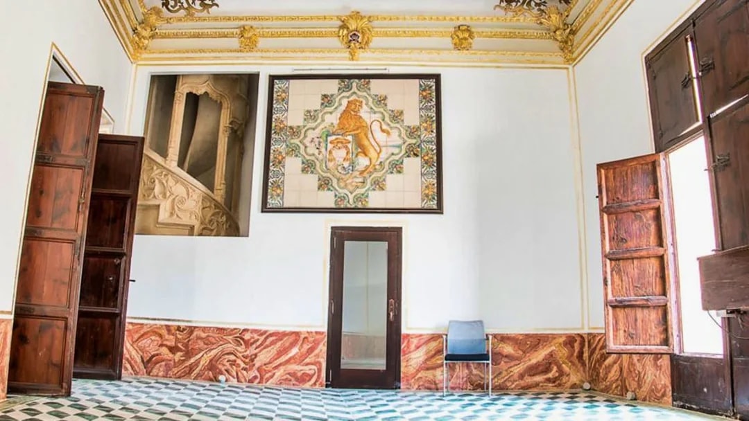 Interior of Silk Museum Valencia with ornate ceiling and decorative wall tiles.