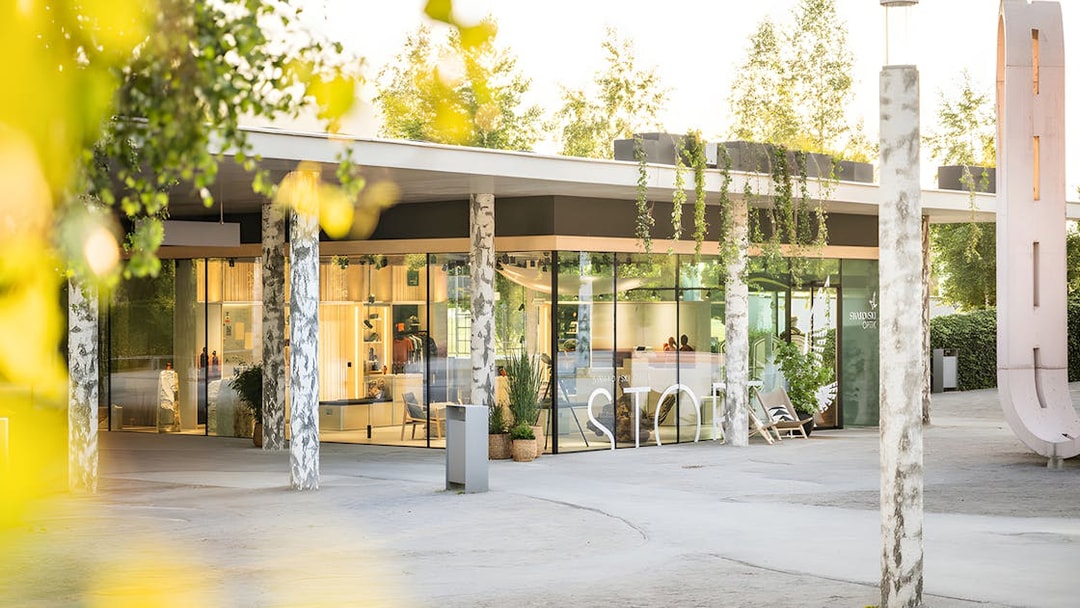 Swarovski Crystal Worlds entrance with modern glass facade and surrounding greenery.