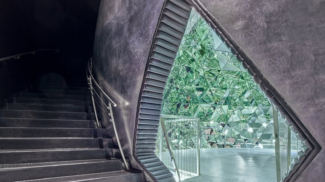 Staircase leading to a mirrored crystal installation at Swarovski Crystal Worlds.