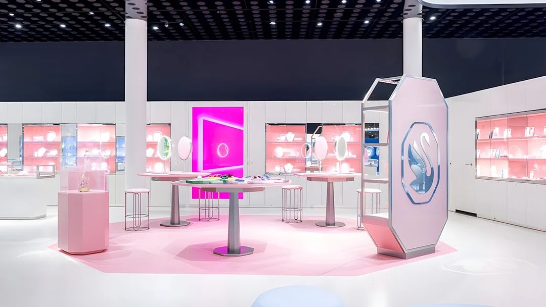 Swarovski Crystal Worlds exhibition room with pink displays and crystal exhibits.