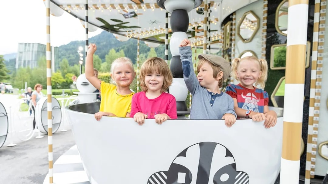 Children enjoying a ride at Swarovski Crystal Worlds, Austria.