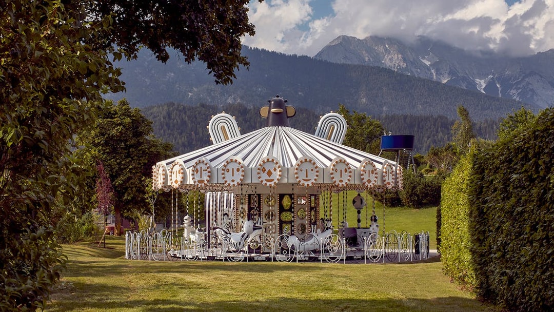 Carousel at Swarovski Crystal Worlds with mountain backdrop, Wattens, Austria.