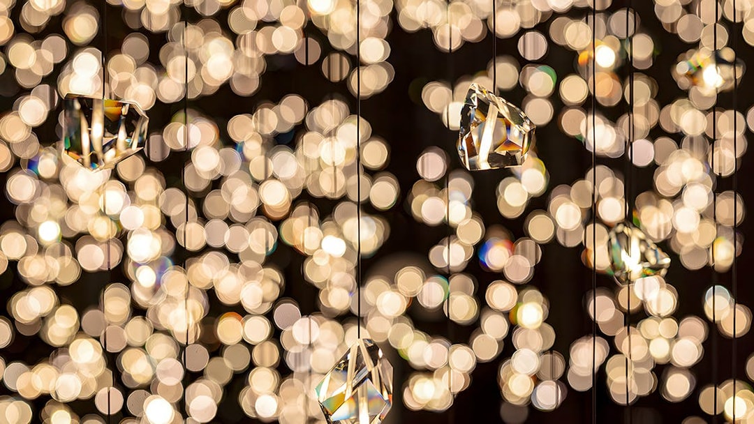 Hanging crystals at Swarovski Crystal Worlds with sparkling light reflections.