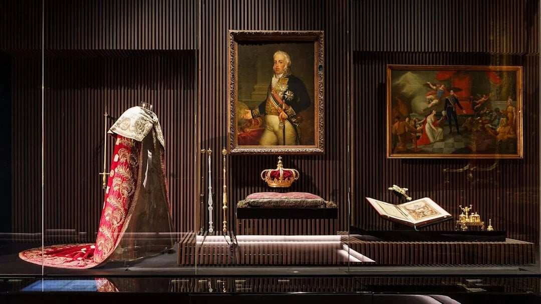 Royal Treasure Museum display with regal robe, crown, and historical paintings.