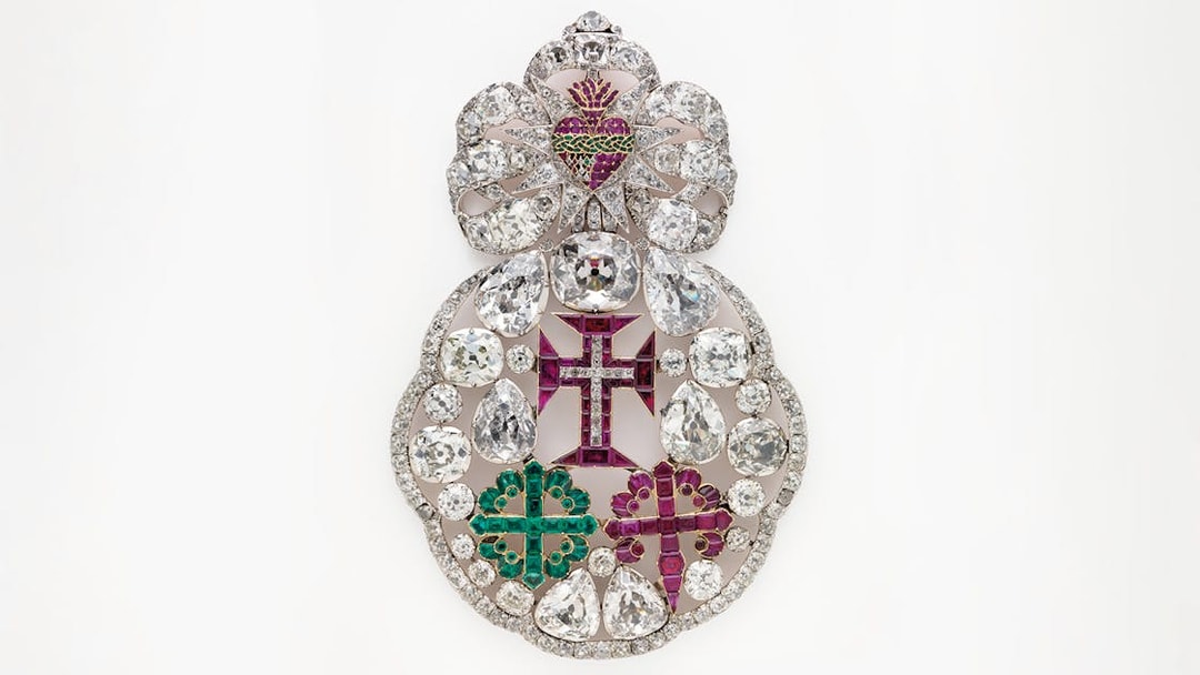 Ornate jeweled brooch with diamonds and colored gems at Royal Treasure Museum.