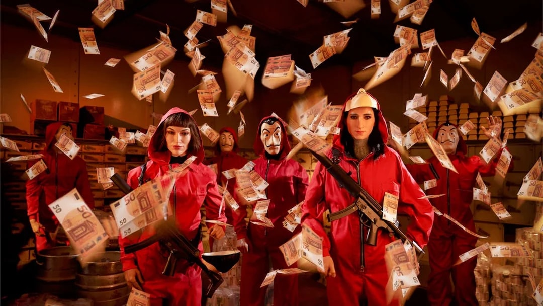 Wax figures in red jumpsuits with masks and money at Wax Museum Barcelona.