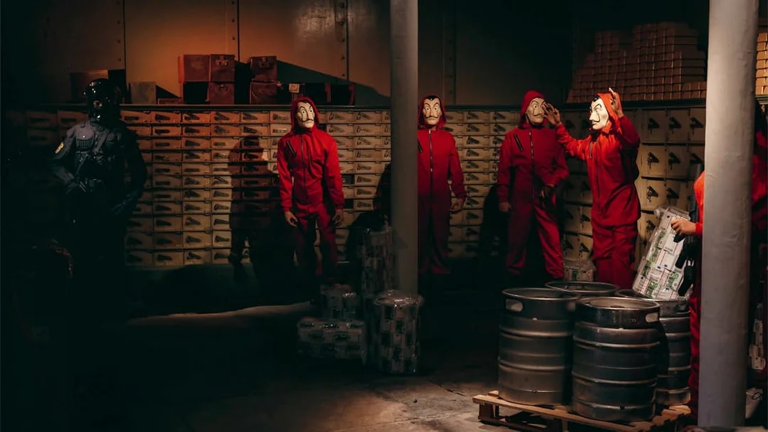 Characters in red jumpsuits and masks at Wax Museum Barcelona.