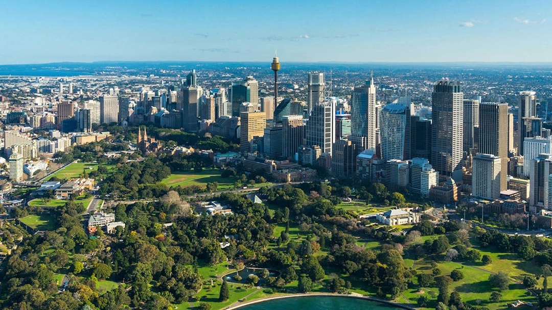 Aerial view of Sydney skyline with Sydney Tower, highlighting SkyFeast dining experience.