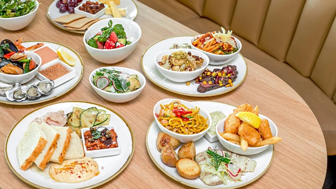 Assorted dishes at SkyFeast, Sydney Tower, featuring seafood, salads, and pasta.