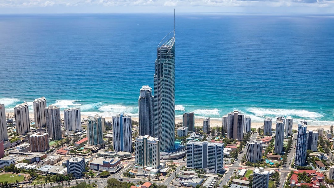 Aerial view of Gold Coast skyline with SkyPoint Observation Deck towering above the city and ocean.