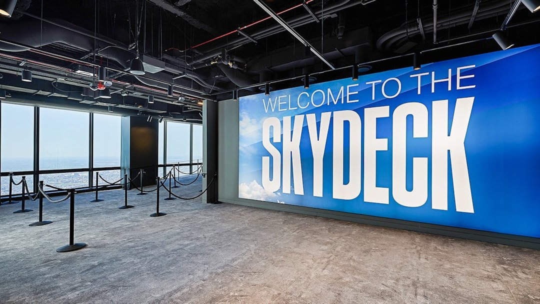 Skydeck entrance at Willis Tower, Chicago with city view through windows.