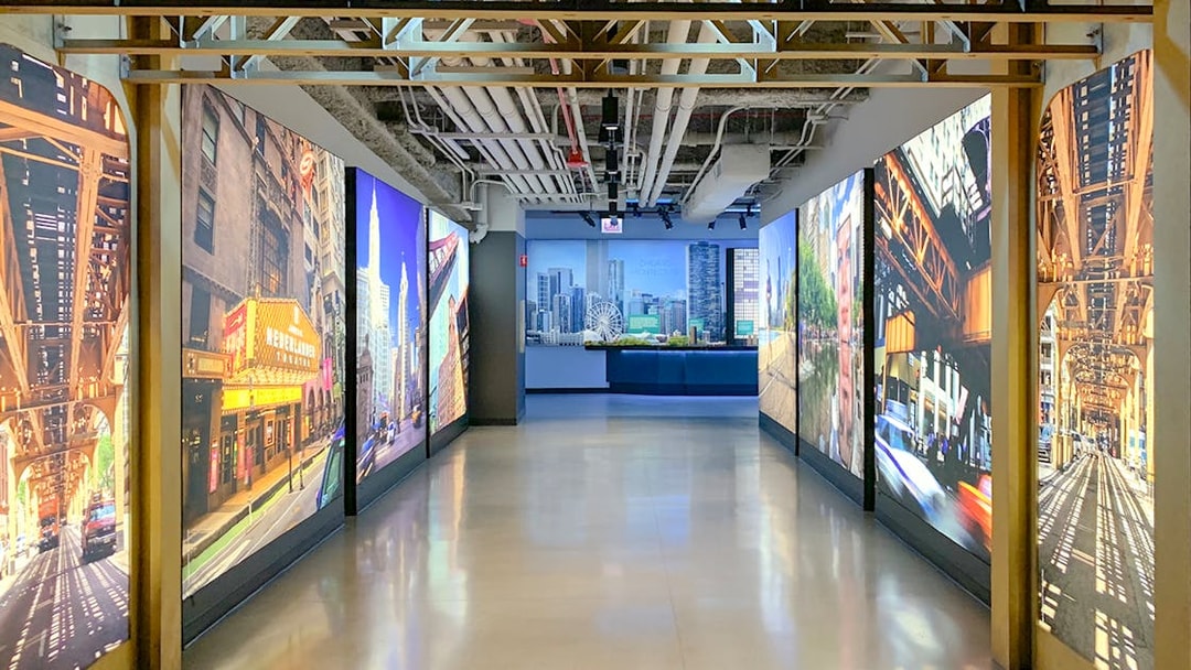 Interactive exhibit hallway at Skydeck Chicago, Willis Tower, featuring cityscape images.