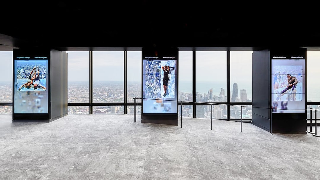 View from Skydeck at Willis Tower, Chicago, overlooking cityscape and Lake Michigan.