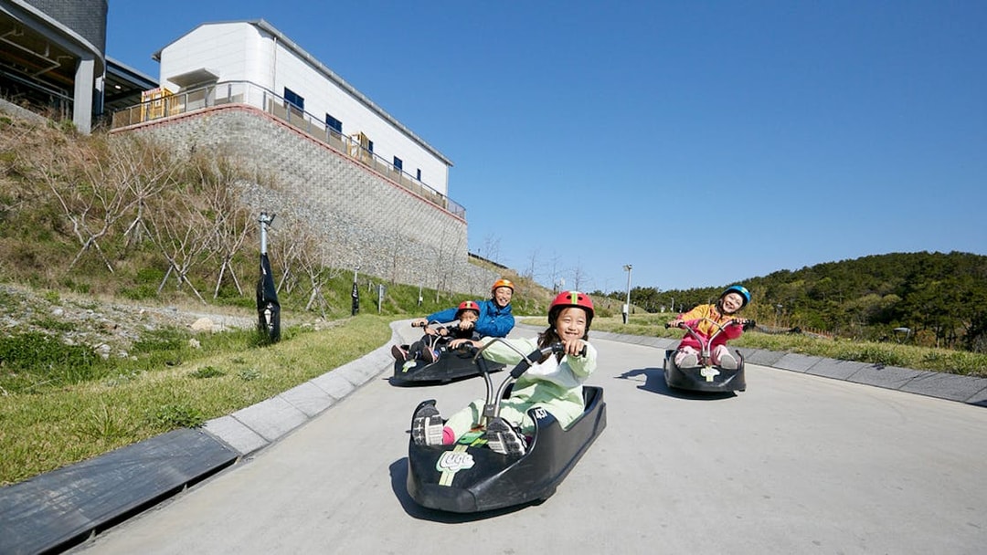 People enjoying a luge ride at Skyline Luge Busan, South Korea.