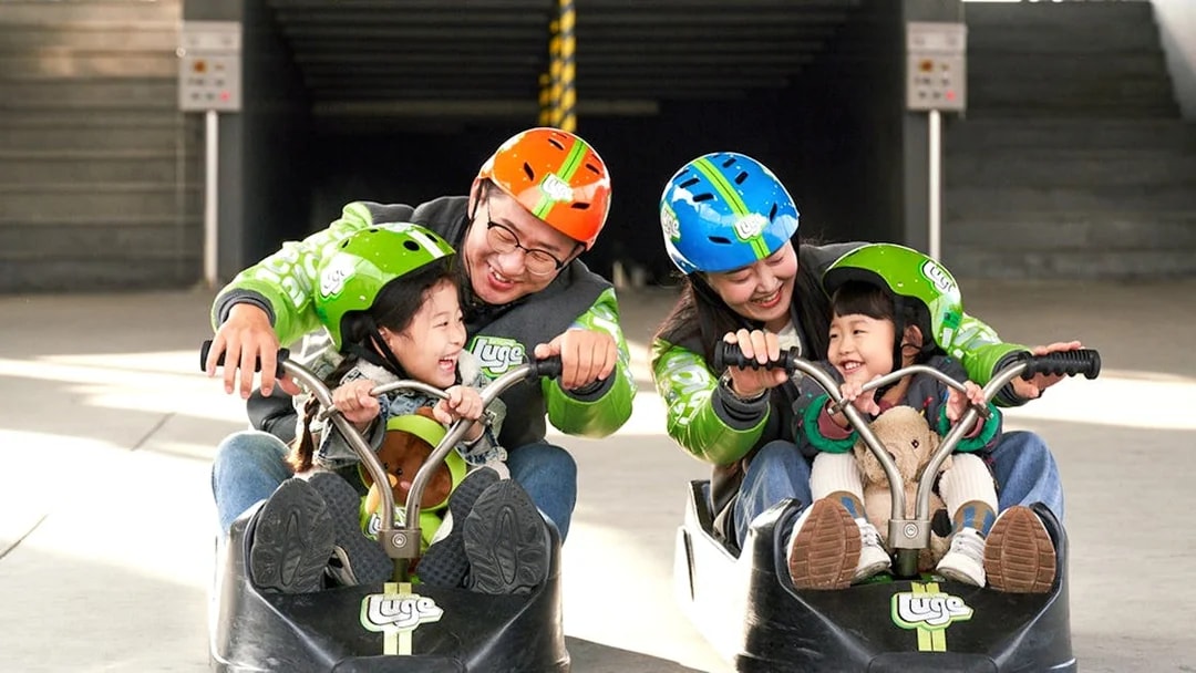 Family enjoying Skyline Luge ride in Busan.