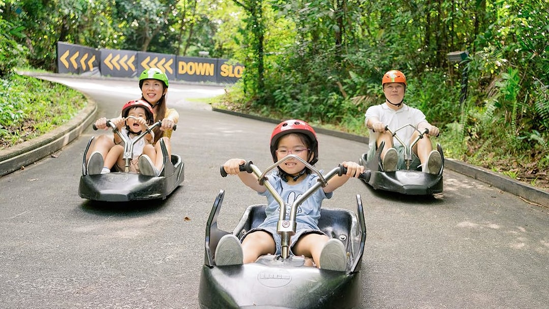 Family enjoying a ride on The Skyline Luge track in Kuala Lumpur.