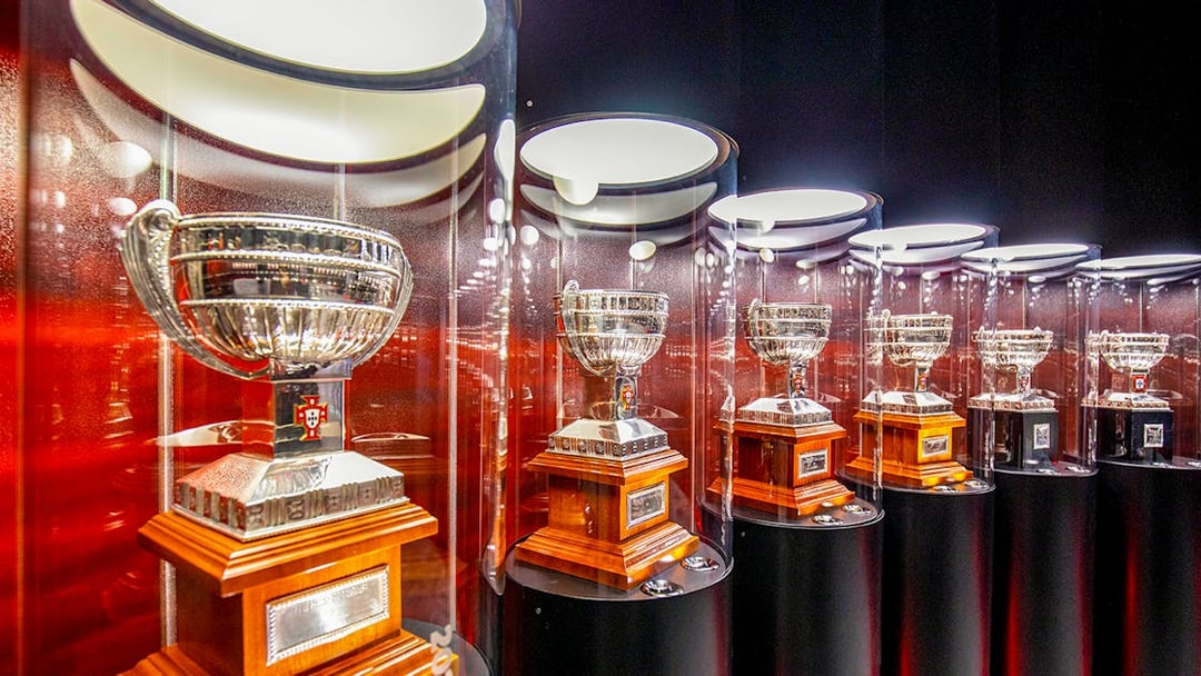Benfica Stadium museum display of silver trophies in glass cases.