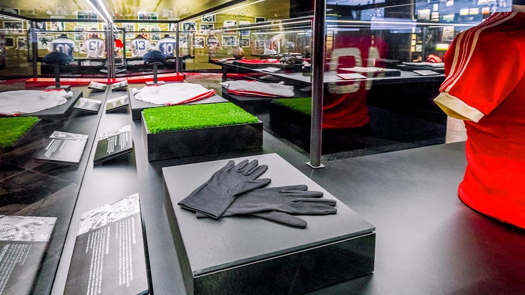 Benfica Stadium museum display with football memorabilia and jerseys.