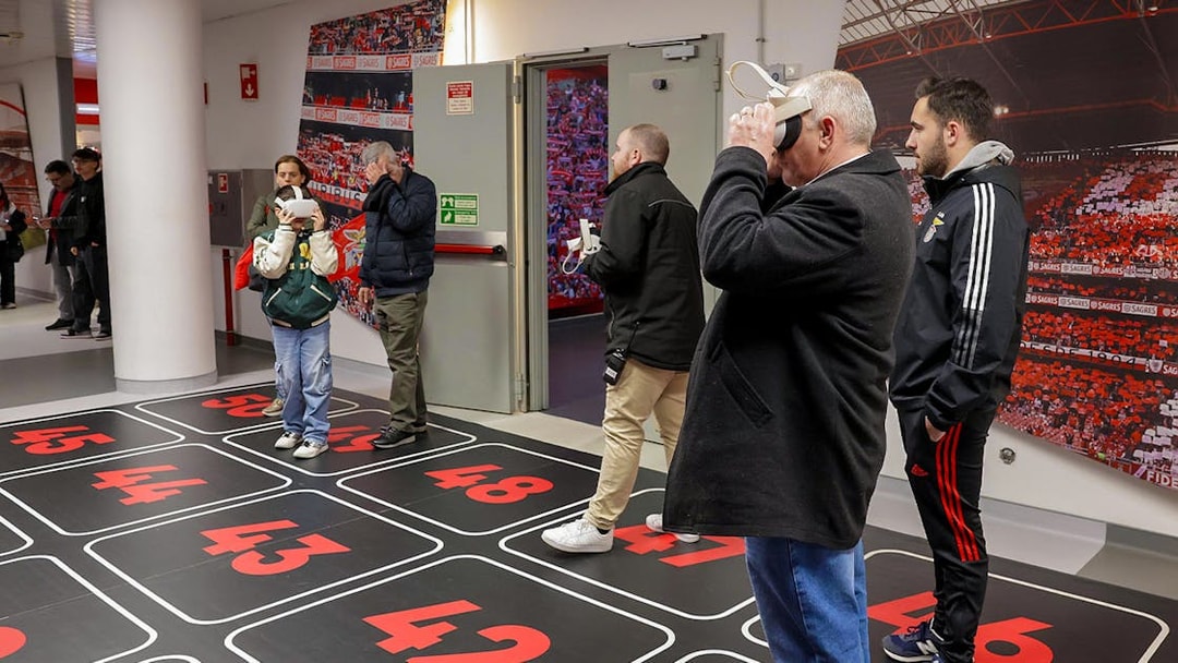 Visitors using VR headsets in Benfica Stadium's virtual reality room.
