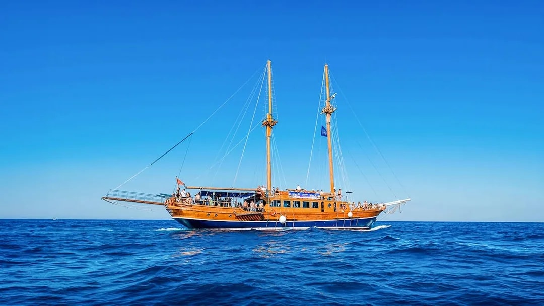 Turkish gulet sailing from Sliema to Gozo and Comino with passengers on deck.