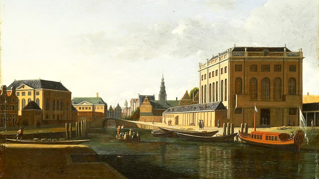Canal view with historic buildings and boats in Amsterdam, part of Small-Group Jewish History Tour.