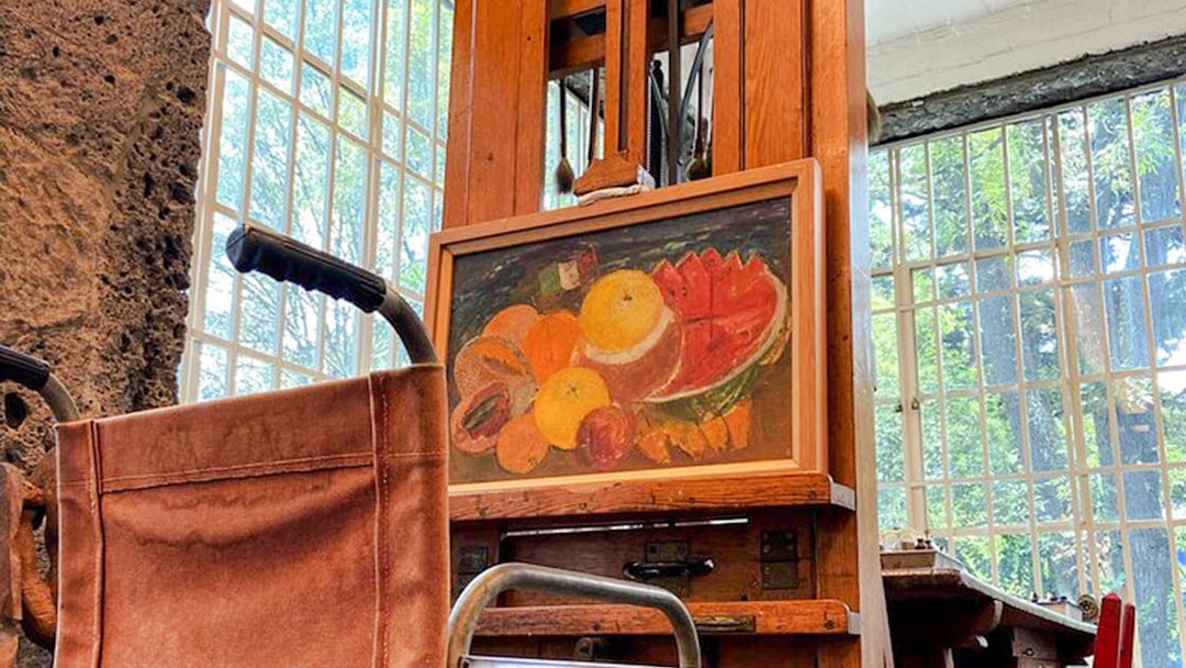 Wheelchair and easel with fruit painting at Frida Kahlo Museum, Mexico City.