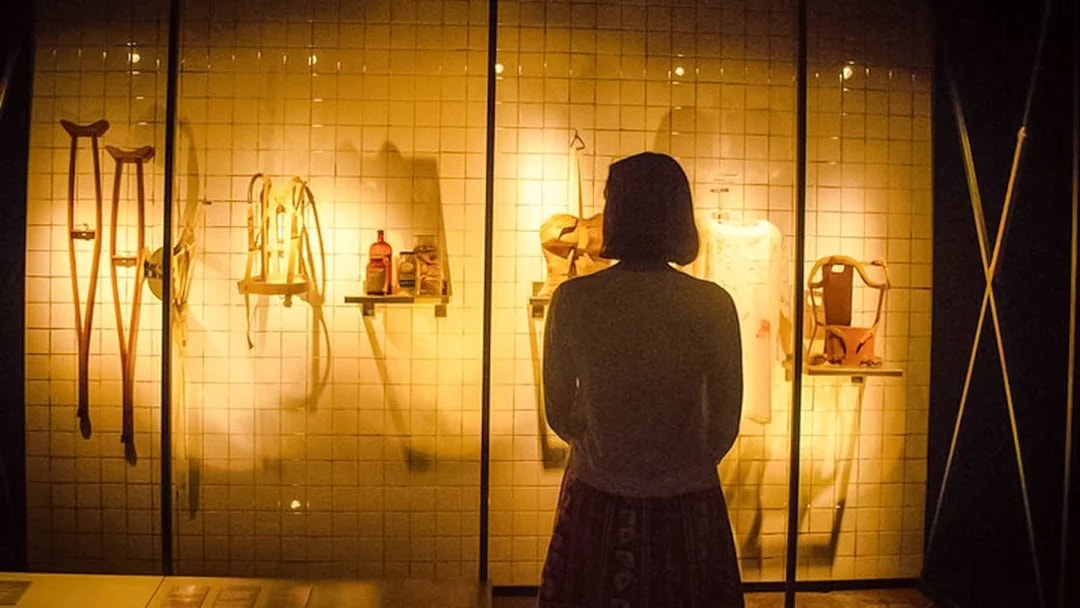 Visitor observing Frida Kahlo's medical artifacts at the Frida Kahlo Museum.