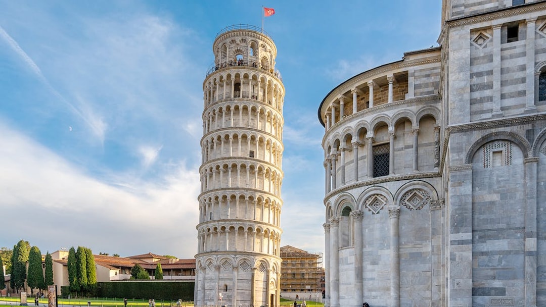 Pisa Cathedral and Leaning Tower with tour group in foreground, Pisa, Italy.