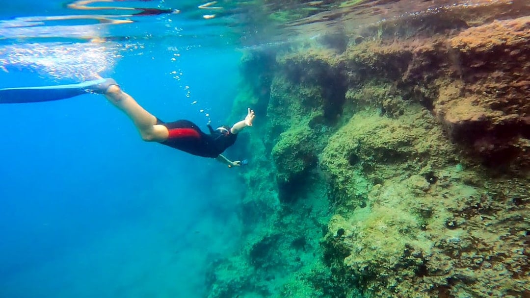 Snorkeler exploring underwater rock formations in Nea Makri, Athens.