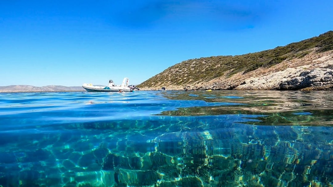 Snorkeling boat near rocky coastline in Nea Makri, Athens.