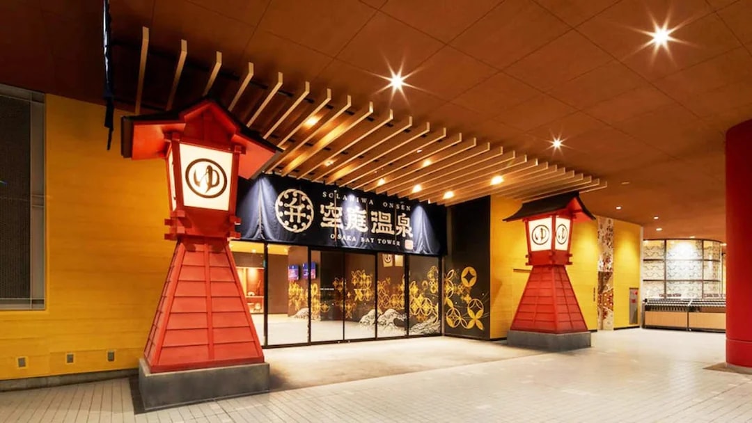 Entrance to Solaniwa Onsen with traditional red lanterns in Osaka, Japan.
