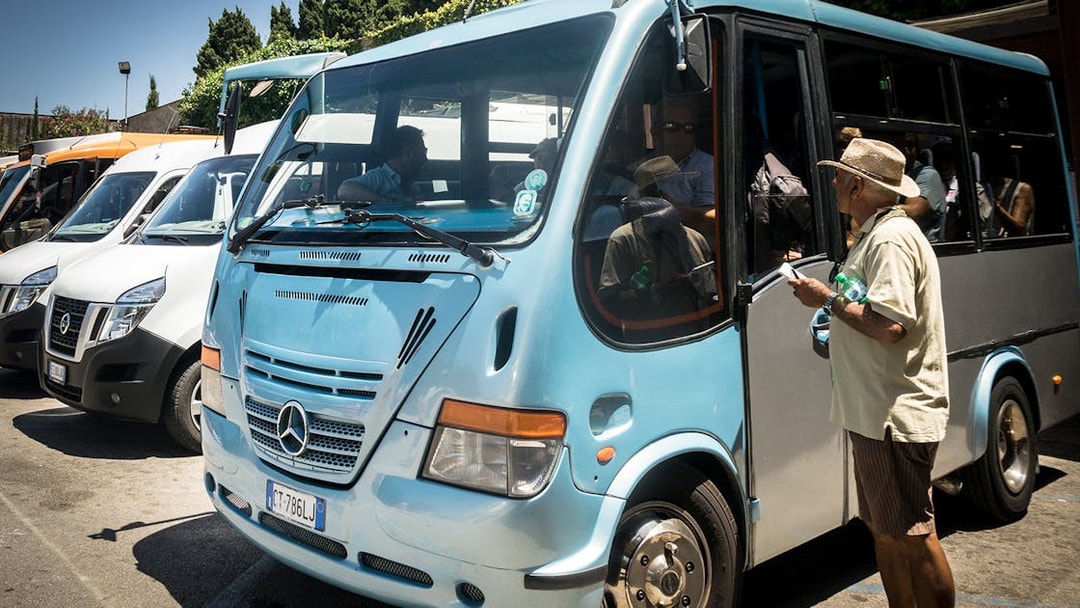 Tourists boarding a bus for Capri and Anacapri tour from Sorrento meeting point.